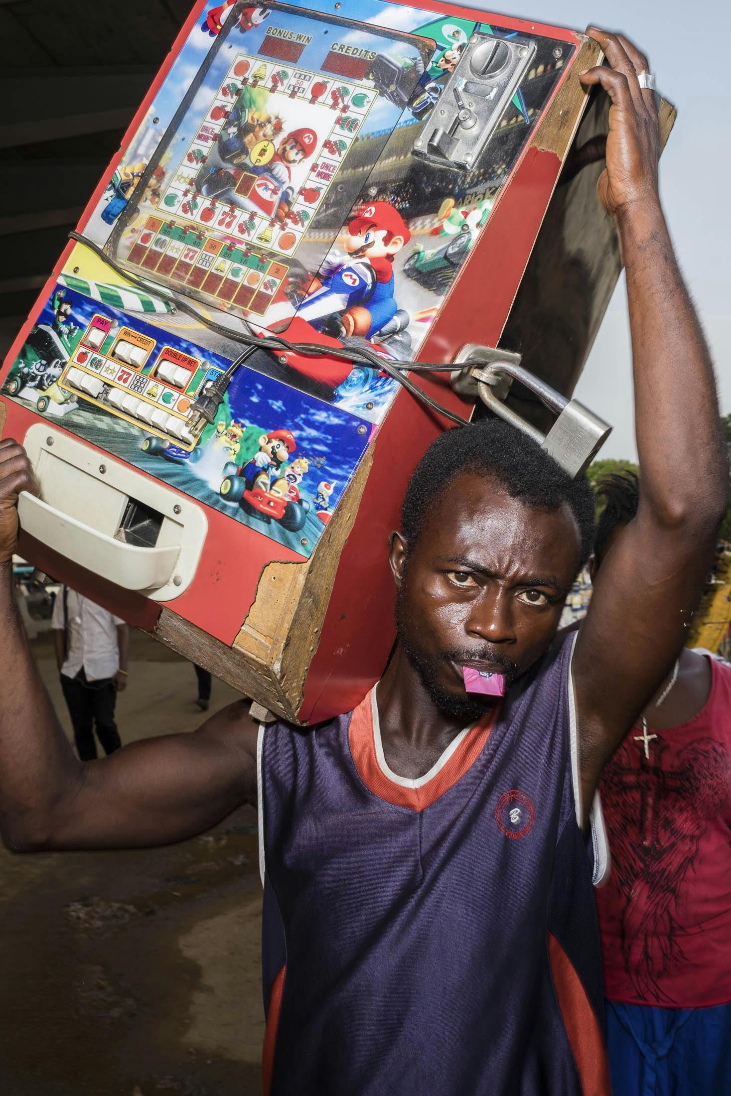 Man carrying super mario machine on the street