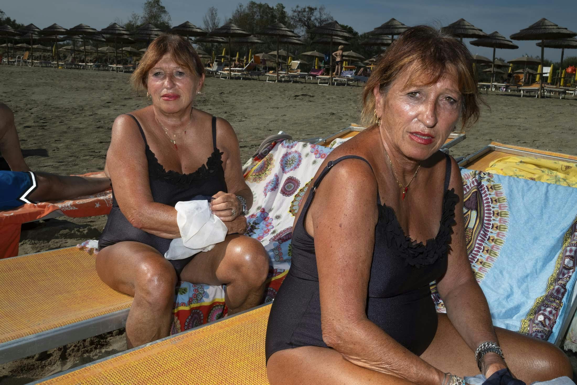 identical twins on beach in italy
