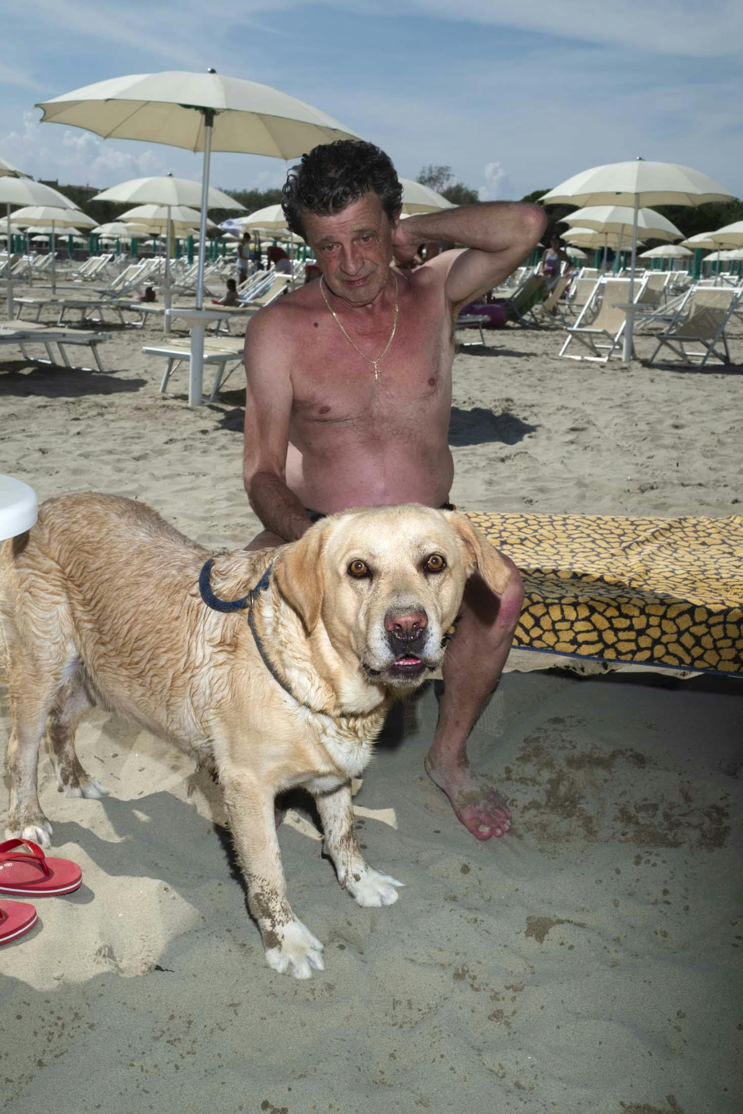 man with dog yellow on beach