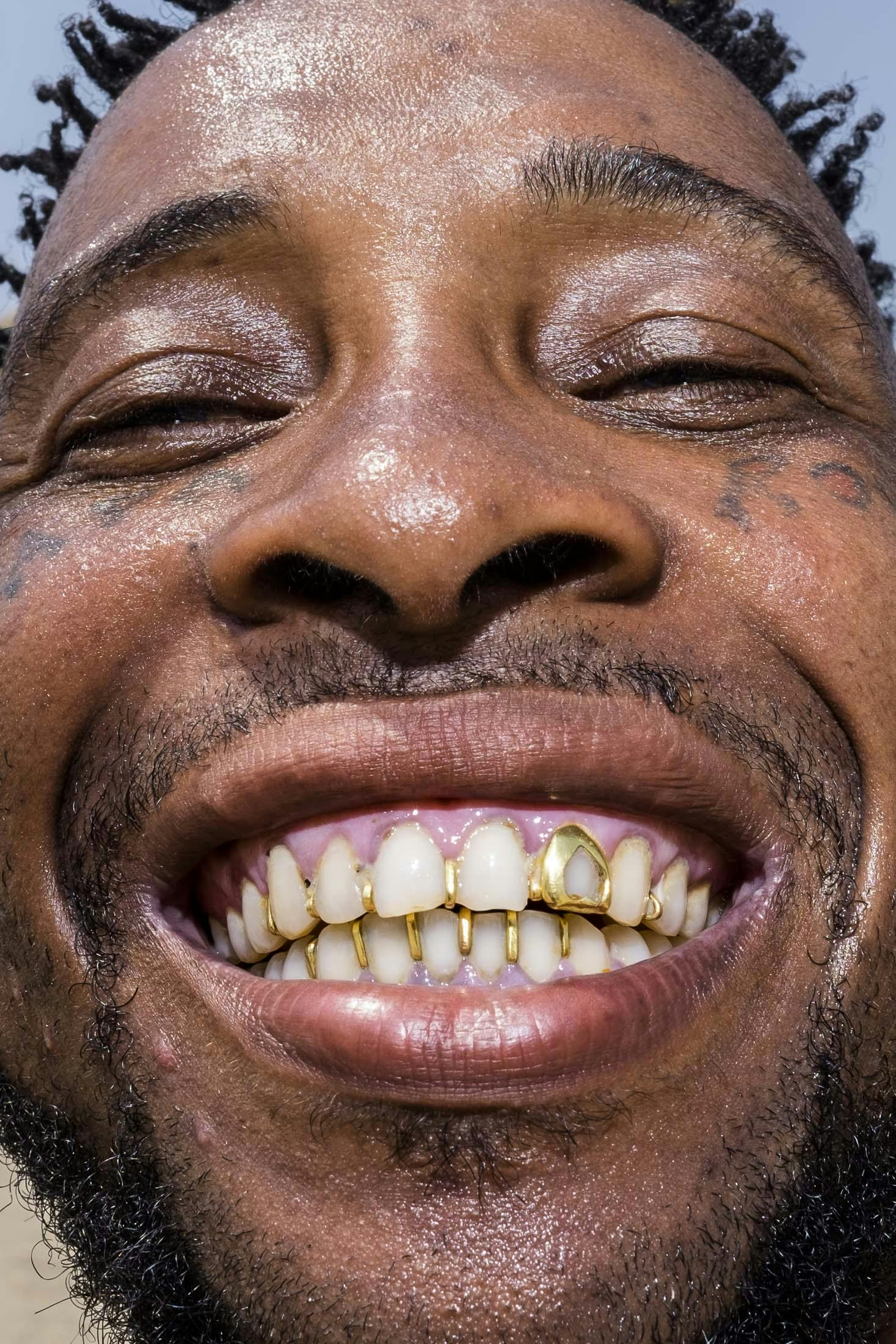Papa row smiling with gold teeth