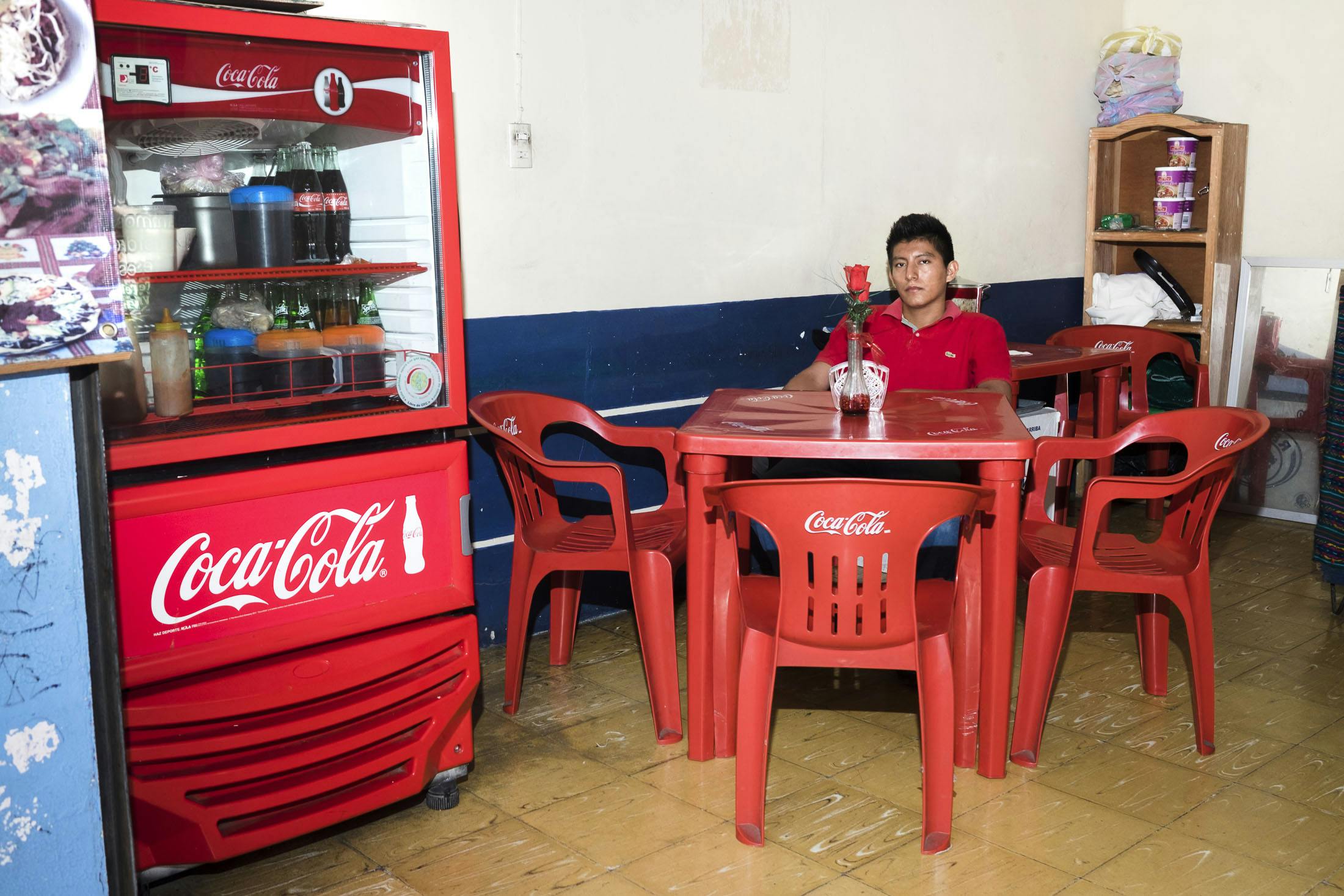 Boy sitting at a coca cola themed restaurant in Mexico