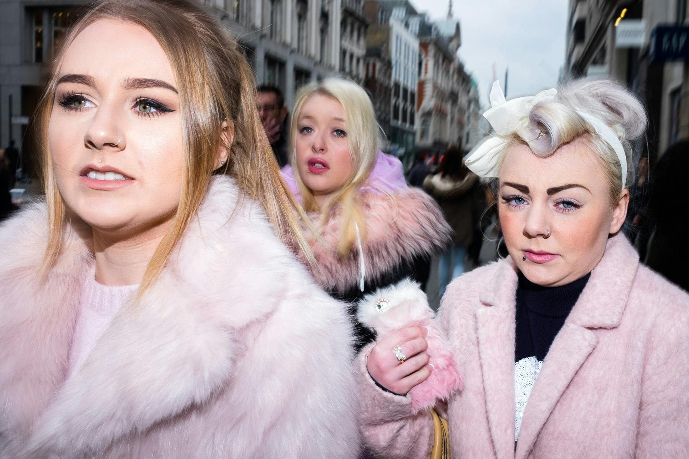 Three girls in pink fur in Oxford Street London