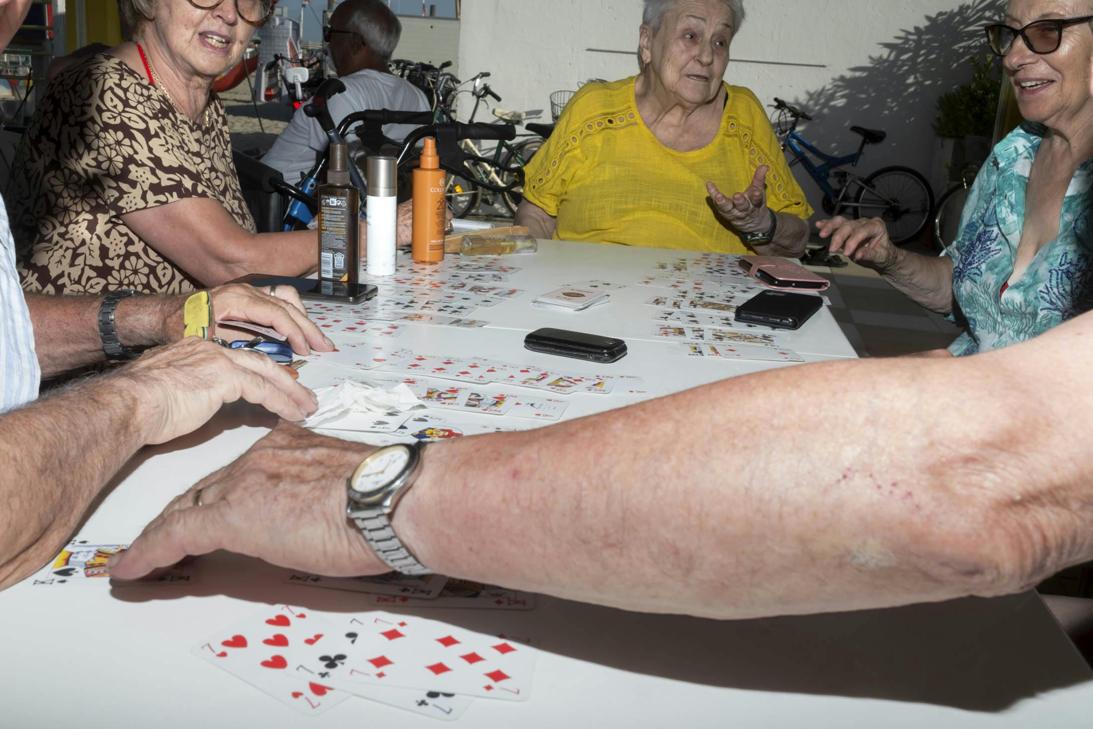 senior people playing cards in italy