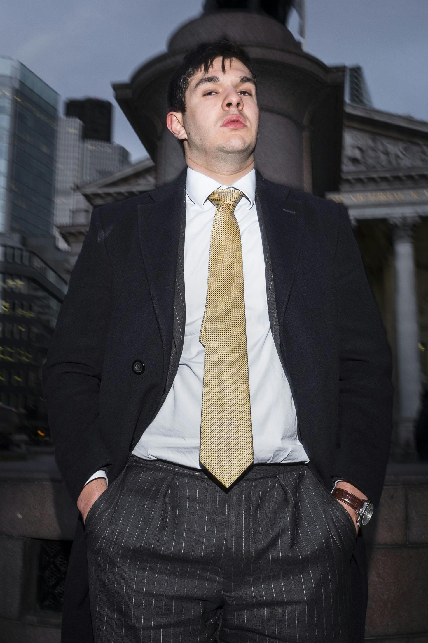 Young business man in pin stripe suits standing in Bank, London.