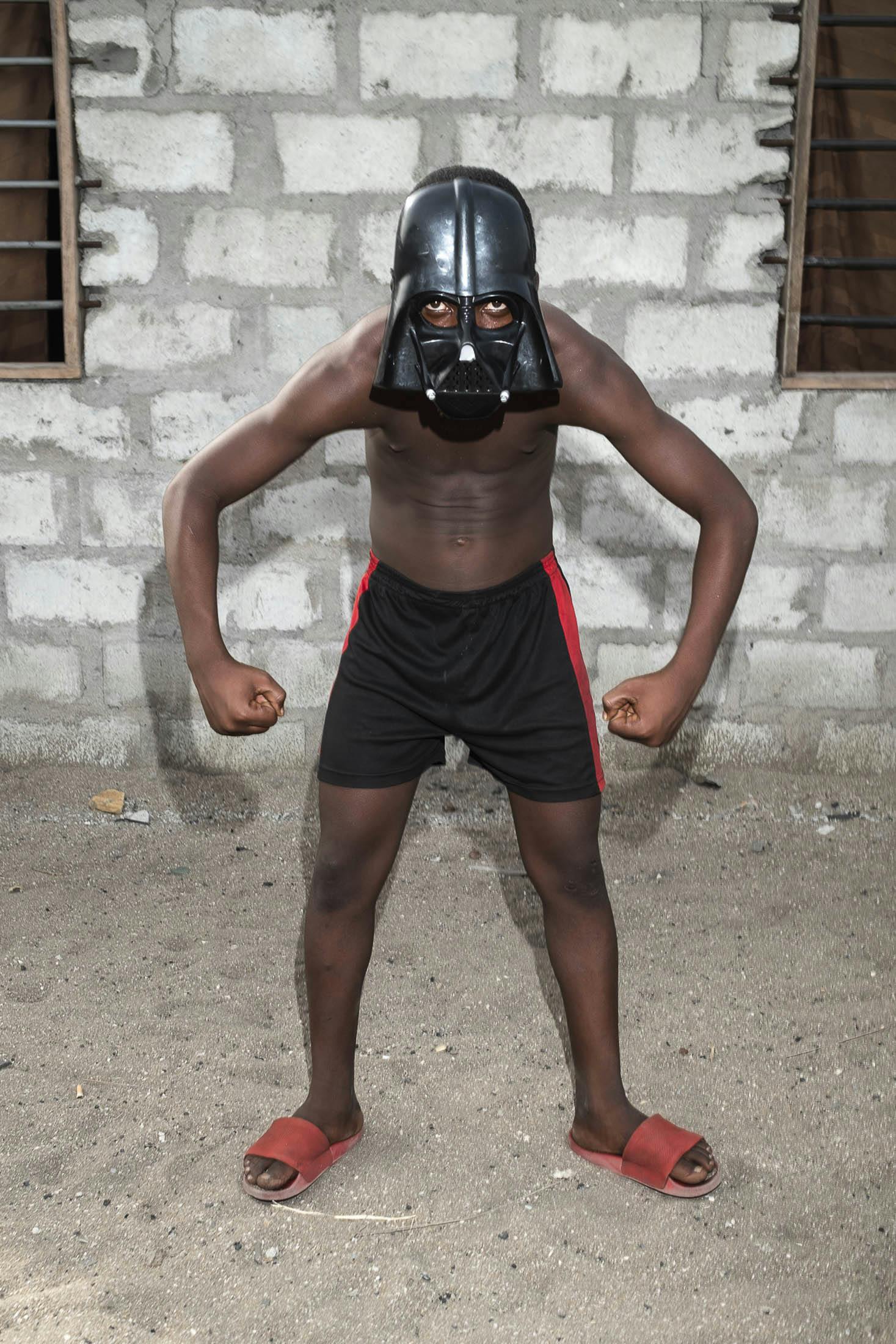 Boy wearing Darth Vadar mask